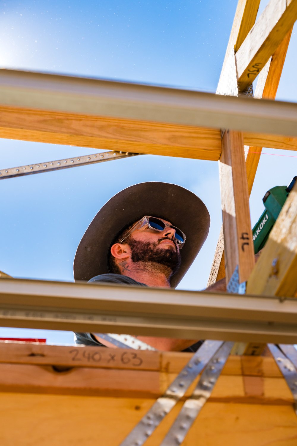 Filming a carpenter framing a roof on site